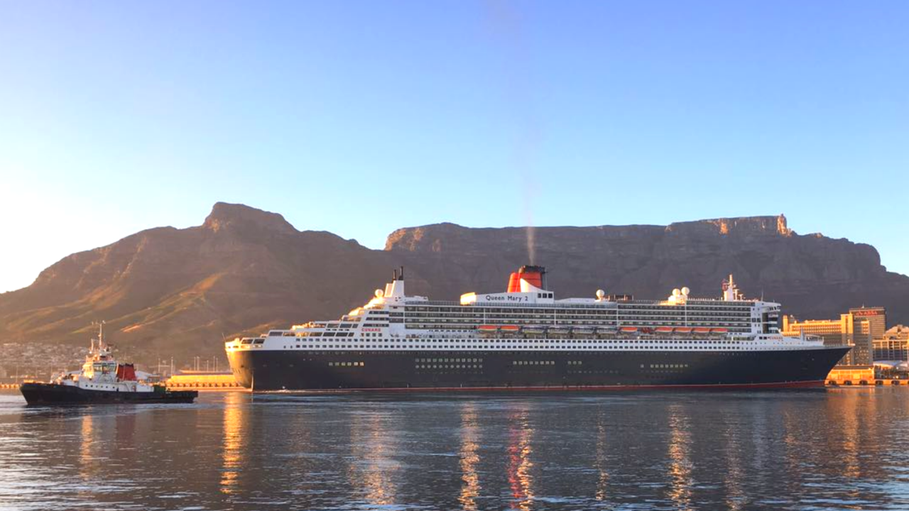 Cunard Queen Mary 2 ocean liner docked in Cape Town harbour with Table Mountain in the background